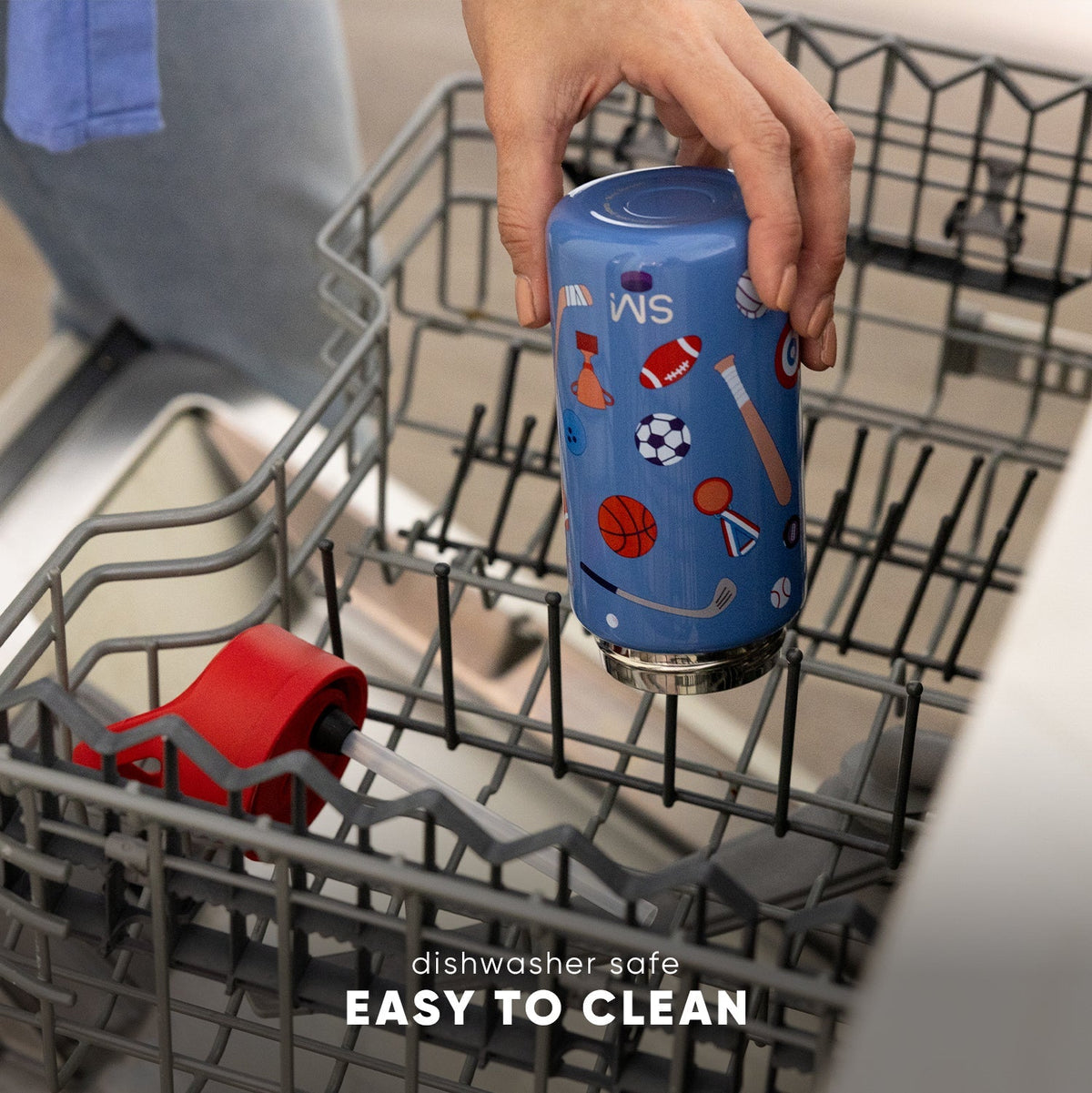 Periwinkle blue kids drinkware bottle with sports icons displayed in open dishwasher basket. Text reads "dishwasher safe" and "EASY TO CLEAN." Simple Modern brand product.