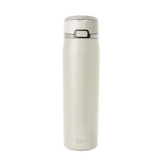 Cream-colored bottle with dark gray accents on neutral beige background