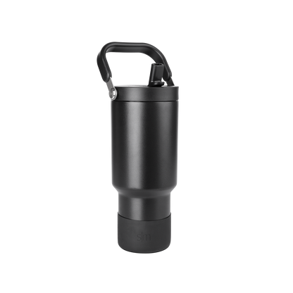 Matte black cylindrical drinkware with metallic gray accents and dark handle against black background